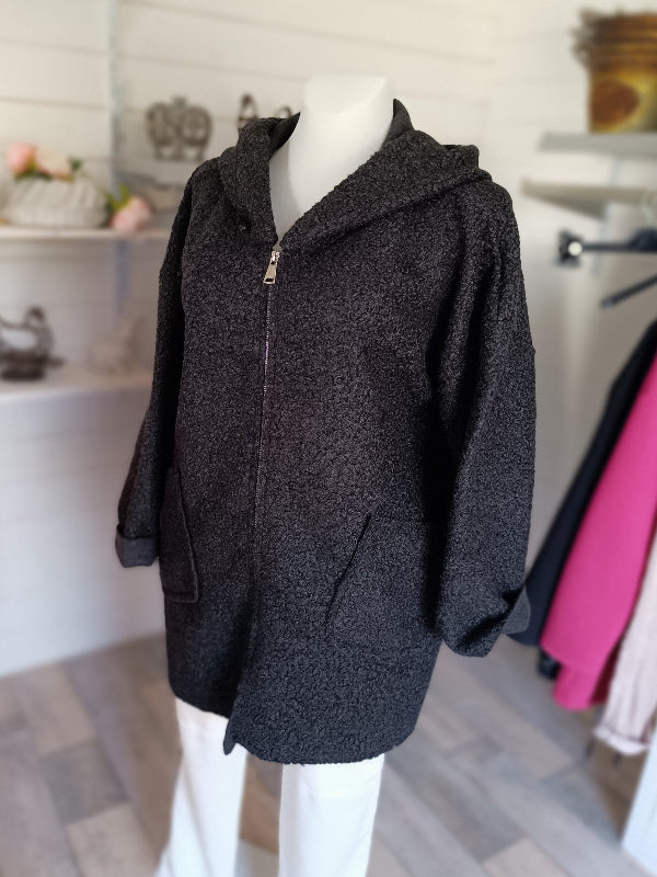 Damenjacke mit Kapuze. Teddyjacke für den Übergang. AA ca. 69 cm. 2 schräg aufgesetzte Taschen. Farbe Schwarz. Länge ca. 82 cm. 100% Polyester.